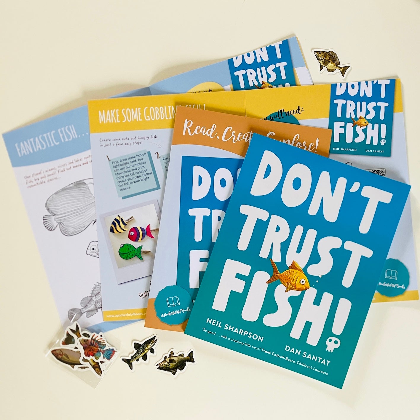Kids monthly book subscription with 'Don't Trust Fish!' by Neil Sharpson. Books and stickers on a light background.