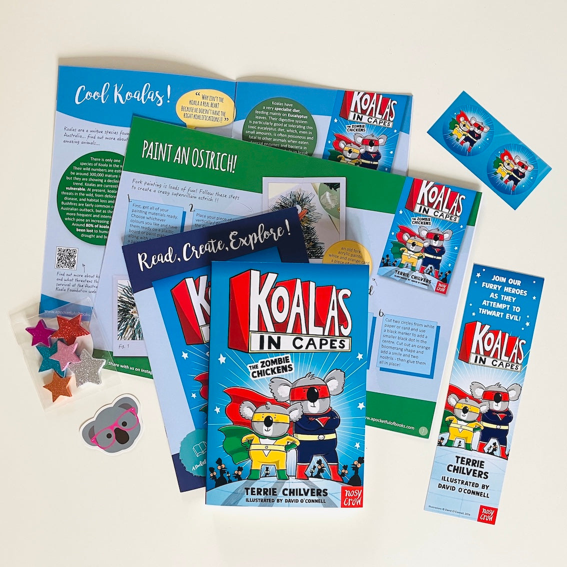 Kids monthly book subscription. Educational materials and book with Koalas In Capes by Terrie Chilvers on a white background.