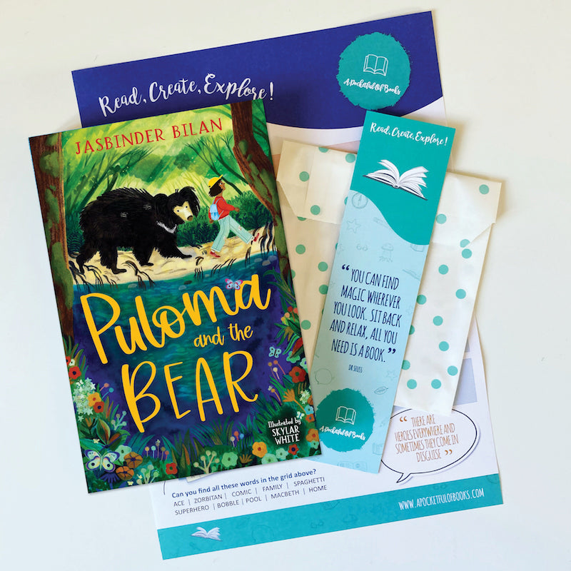 Book titled 'Puloma and the Bear' by Jasbinder Bilan with bookmarks and a card on a white background